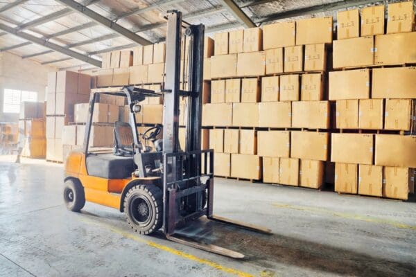 A forklift is parked in front of boxes.