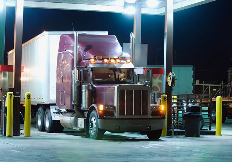 A truck is parked at the gas station.